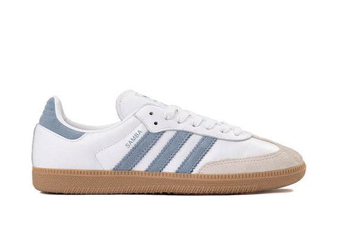 White sneaker with blue accents and brown sole on a white background