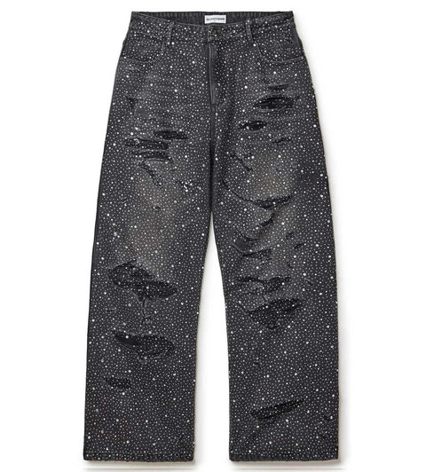 Black distressed jeans with white stones on a white background