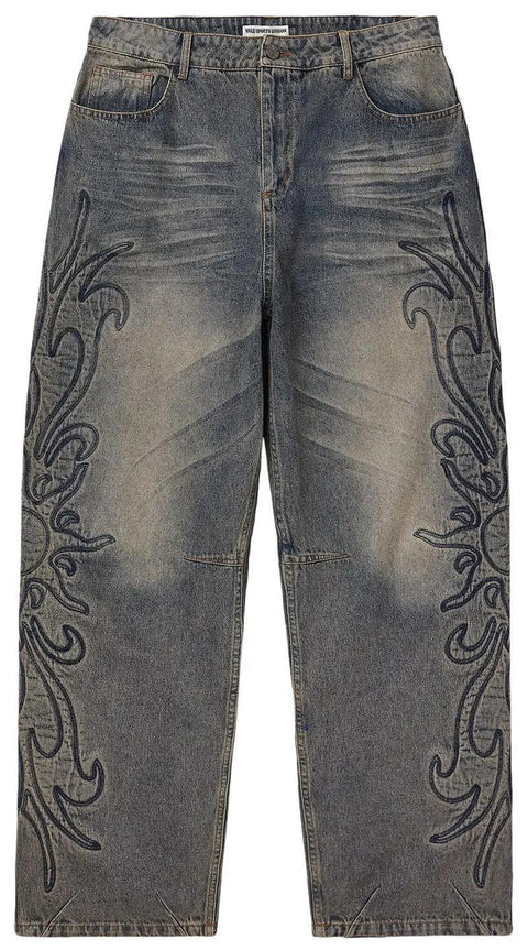 Distressed jeans with decorative patterns on a white background