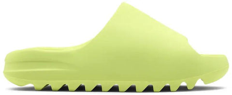 Yellow slide sandal with textured sole on a white background
