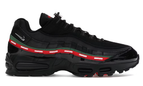 Black sneaker with red and green accents on a white background