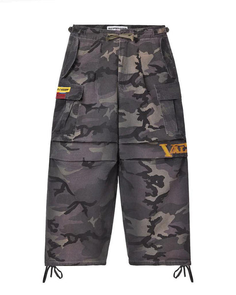 Camouflage cargo pants with brand logos on a white background