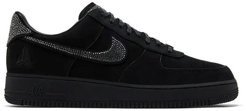 Black sneaker with rhinestone embellishments on a white background
